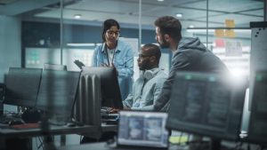 employees gathered around a computer